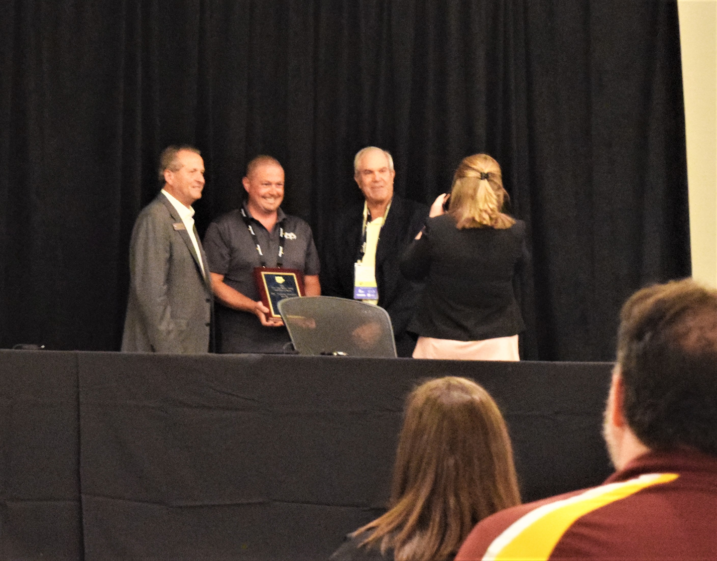 A safety rep from Oregon-headquartered May Trucking accepted a finalist plaque in the contest from TCA President John Lyboldt (left) and a representative from awards-program sponsor Great West Casualty company.