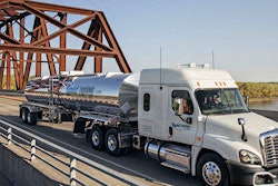 semi truck driving across bridge