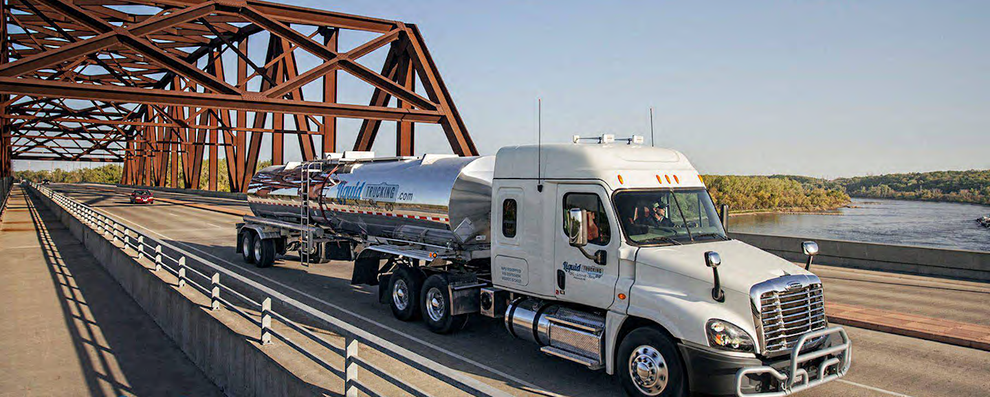 semi truck driving across bridge