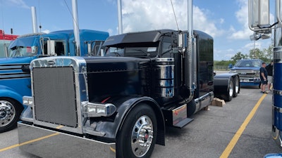Speaking of Equipment Express, the company has four trucks on display at the show, including this blacked-out 2005 Peterbilt 379 flattop.