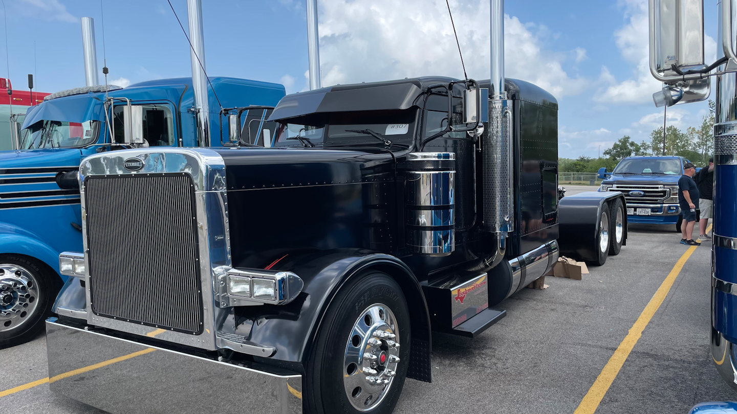 Speaking of Equipment Express, the company has four trucks on display at the show, including this blacked-out 2005 Peterbilt 379 flattop.