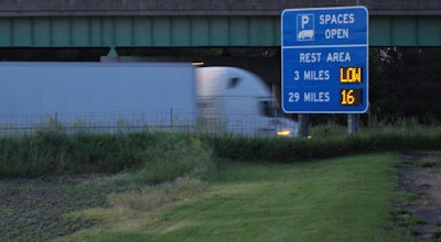 truck passing parking highway sign