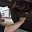 man performing brake inspection