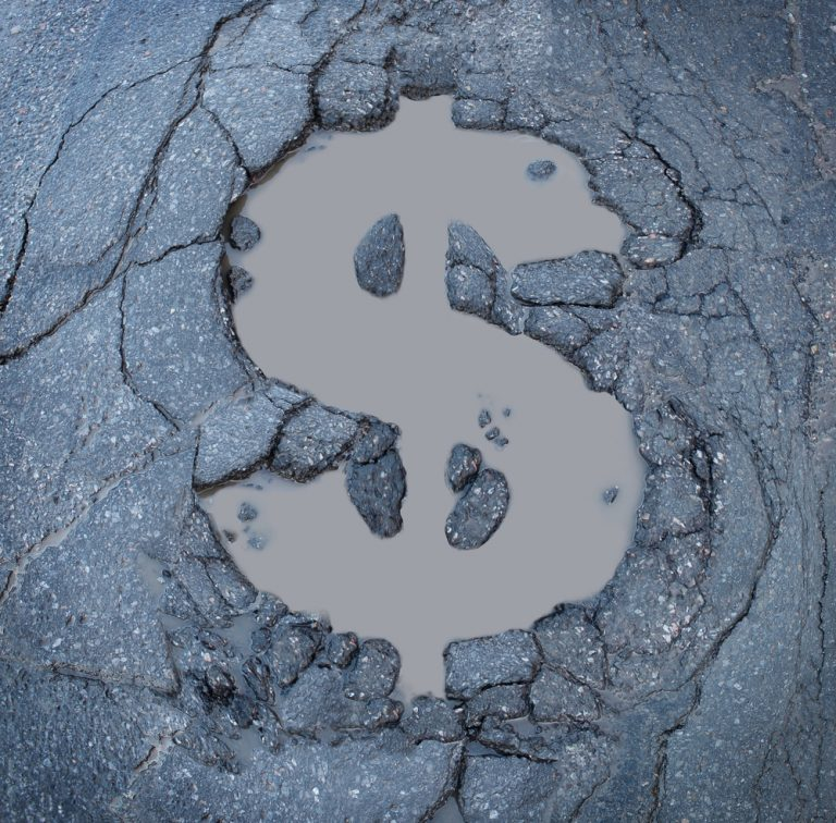 pothole in shape of dollar sign