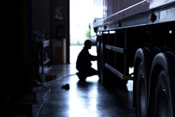 Technician working on truck tire