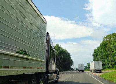 Trucks on highway with one broken down