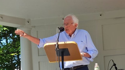 Bernie Sanders speaking at a podium