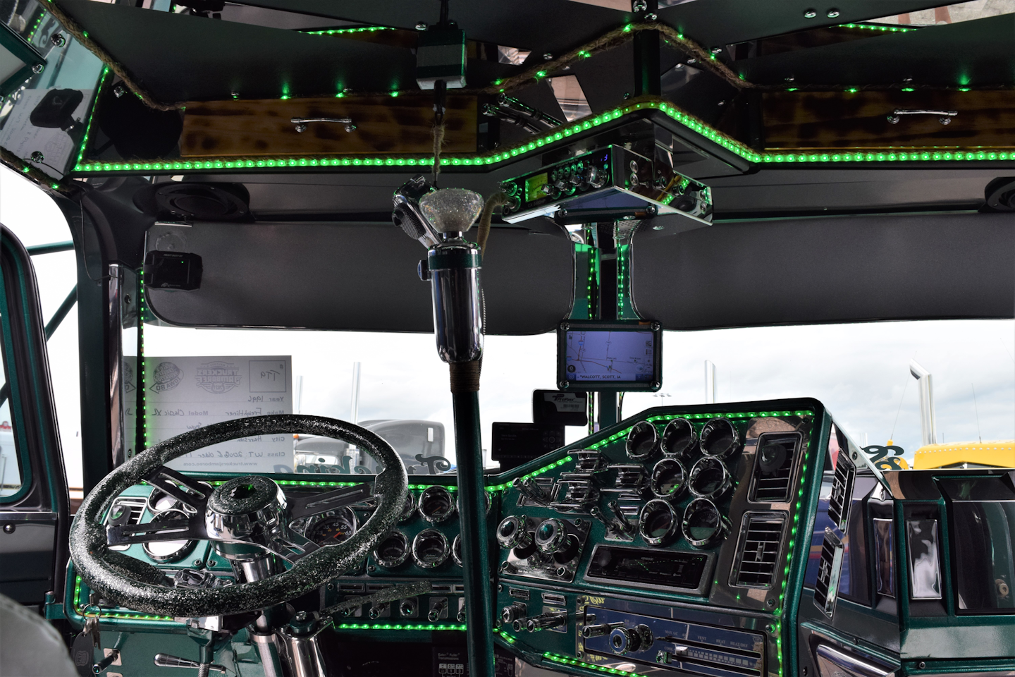 Like the bunk, the cab of 'The Goose' is also adorned with lights. The dash, steering wheel, shifter and more are green to match the rest of the rig.