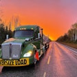 ptsi truck hauling an oversized load at sunrise
