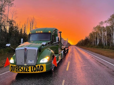 ptsi truck hauling an oversized load at sunrise