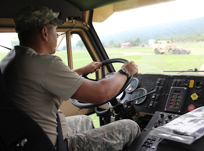 A soldier in the National Guard drives a truck