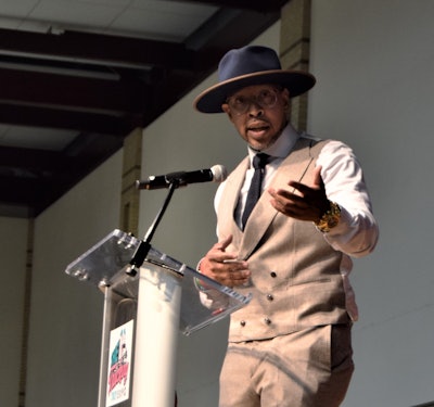 Adam Wingield speaking into a microphone