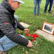 Dave Dein laying wreath on father Philip Dein's grave