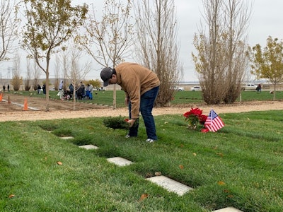 Laying a wreath on a grave in San Joaquin Valley National Cemetery