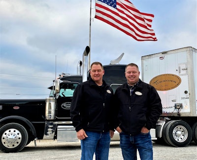 Wayne and Shane Timmons standing in front of a Timmons Transit semi-truck