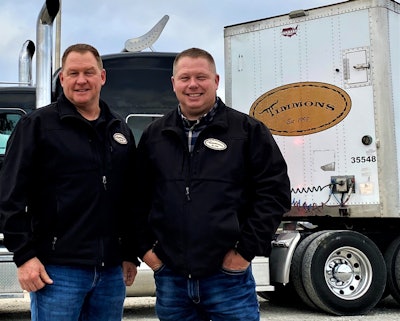 Wayne and Shane Timmons standing in front of a Timmons Transit semi-truck