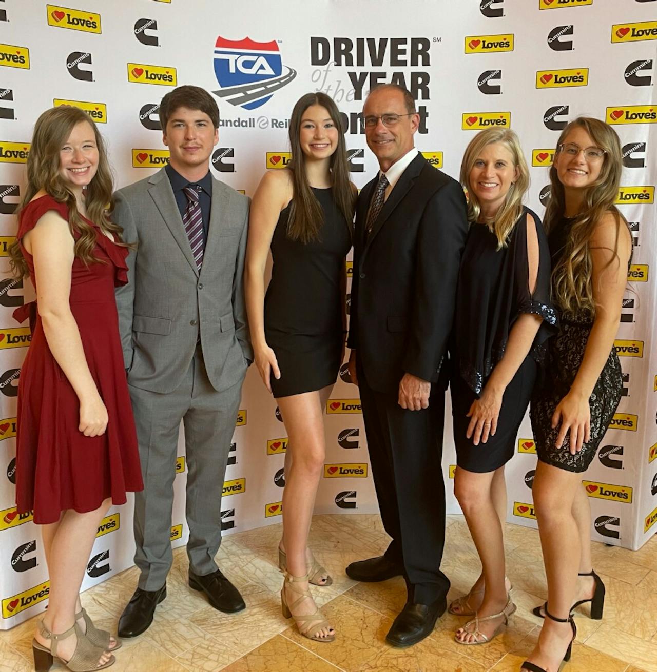 Smith's a proud dad, it's certain, and it's clear his daughters share in that. All were able to be on hand for the unveiling of his Owner-Operator of the Year honor in October in Las Veags. From right: Daughter Bethany, currently in college; Martha and Bryan; daughter Vivian, still in high school and quite a volleyball player; Austin Bostic and Smith's eldest daughter, Emily Bostic. 'Austin drives truck for First Fleet,' Smith noted. Yes, Emily married a truck driver. 'Takes after her mother, I guess.'