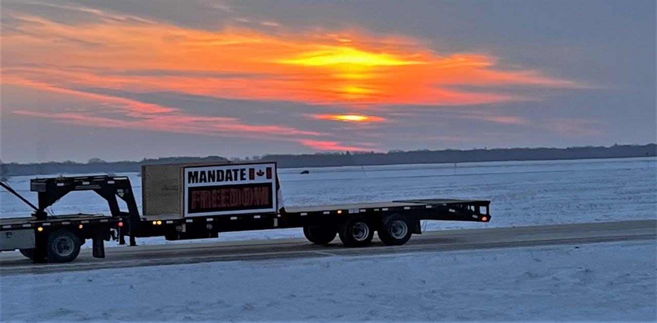 'For those guys to be out there that early on a Saturday it was crazy,' Davis said. 'I can only imagine what happened later on in the day.' In the picture, the sign on the trailer deck might be a little hard to read -- it's urging a mandate for 'FREEDOM,' in capital letters against the black.