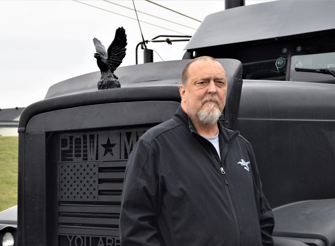 Chuck Timbrook in front of Black Out truck