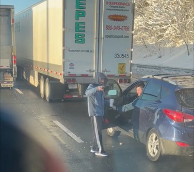 A trucker hands out warm food during the shutdown on I-95. Image taken from a video posted below by @JCGachet96 on Twitter.