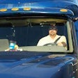 driver in cab of truck in sunlight