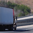 Tractor-trailer on the highway, approaching a bridge