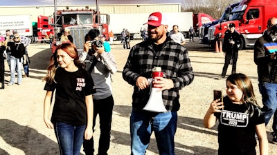 Brase, with megaphone, leading the choir.
