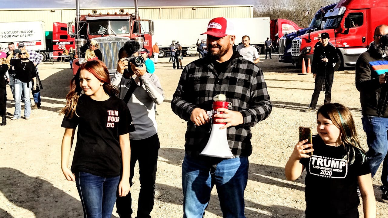 Brase, with megaphone, leading the choir.