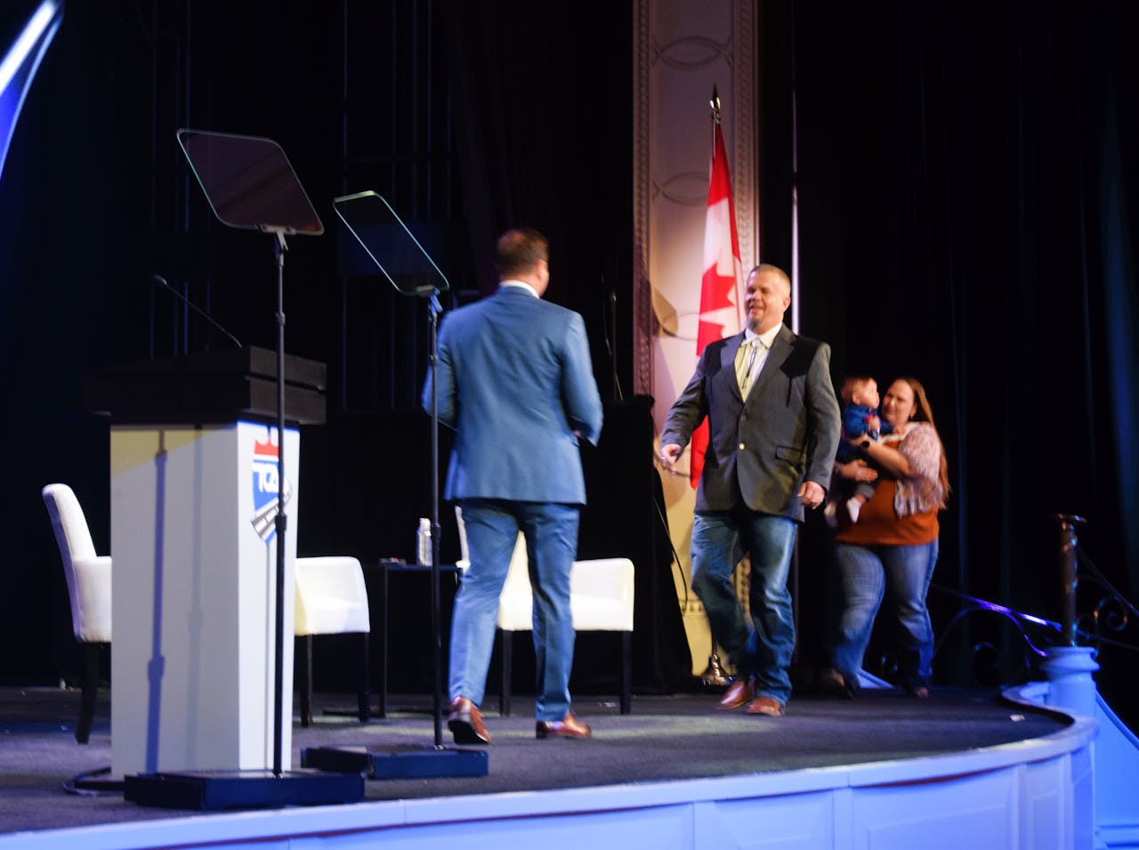 Lloyd, with his wife and child, walked onto the stage to accept the 2021 Highway Angel of the Year award from EpicVue's Lance Platt.