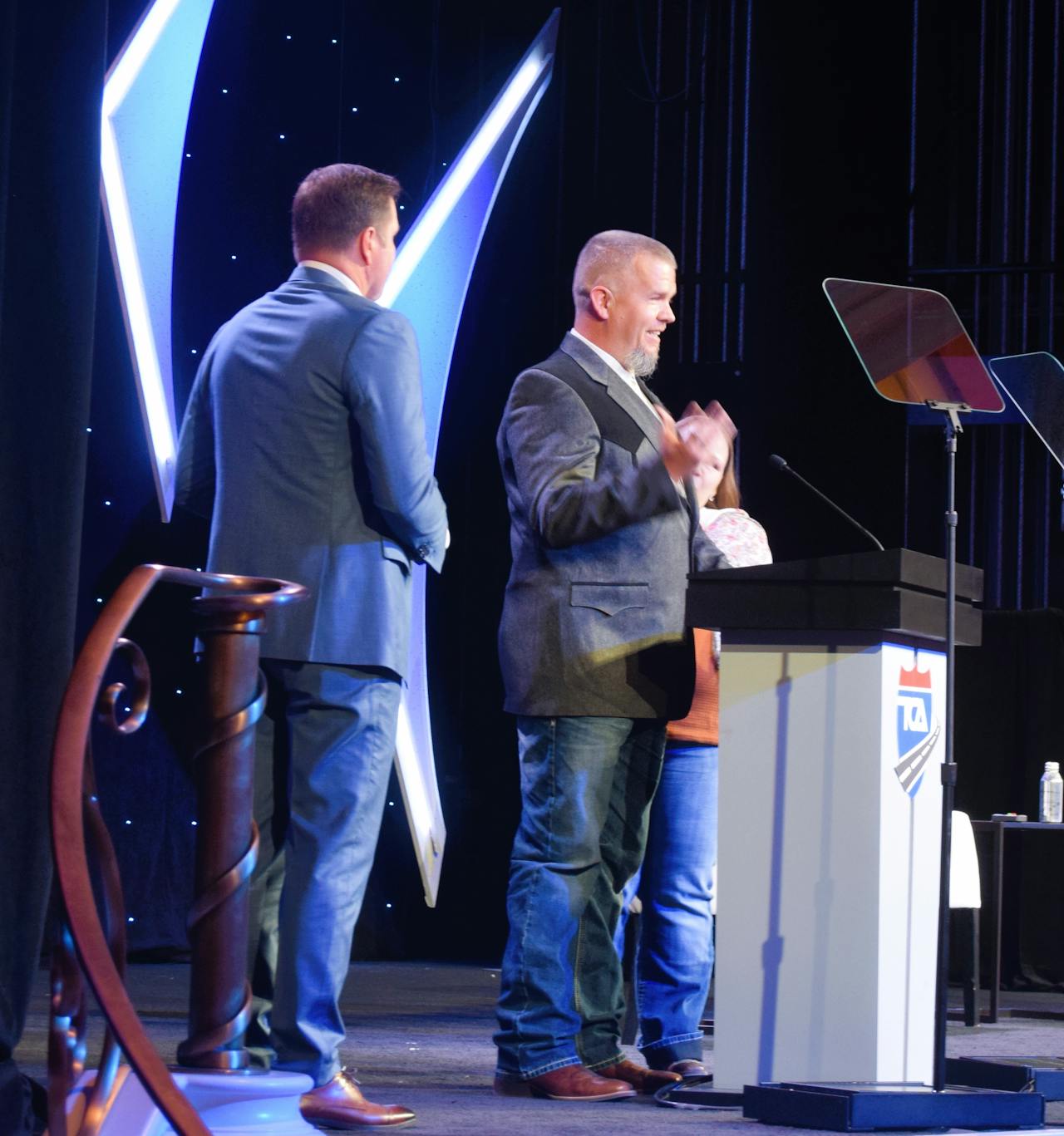 Chris Lloyd speaking from the stage at the TCA conference. He thanked the organization for the recognition, noting he was glad he was in the right place at the right time to be able to help.