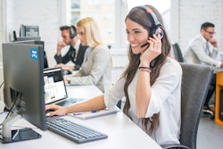 Female dispatcher using a computer and headset