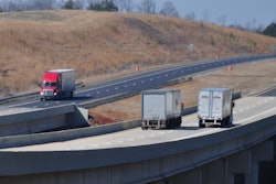 Pair Of Trucks On Highway Bridge