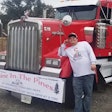 Dakota McDaniel standing beside his Kenworth truck