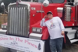 Dakota McDaniel standing beside his Kenworth truck