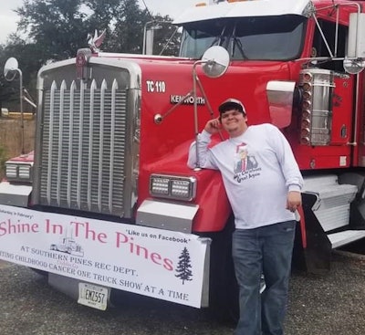 Dakota McDaniel standing beside his Kenworth truck