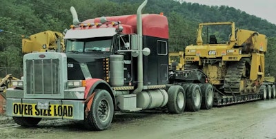 semi hauling heavy equipment