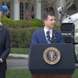 Transportation Secretary Pete Buttigieg and President Joe Biden in front of trucks