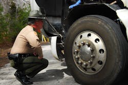 Tennessee roadside inspector inspecting a wheel