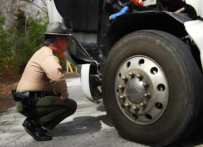 Tennessee roadside inspector inspecting a wheel