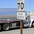Speed limit sign with truck in background