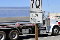 Speed limit sign with truck in background