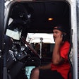 owner-operator talking on cell phone in truck's driver seat