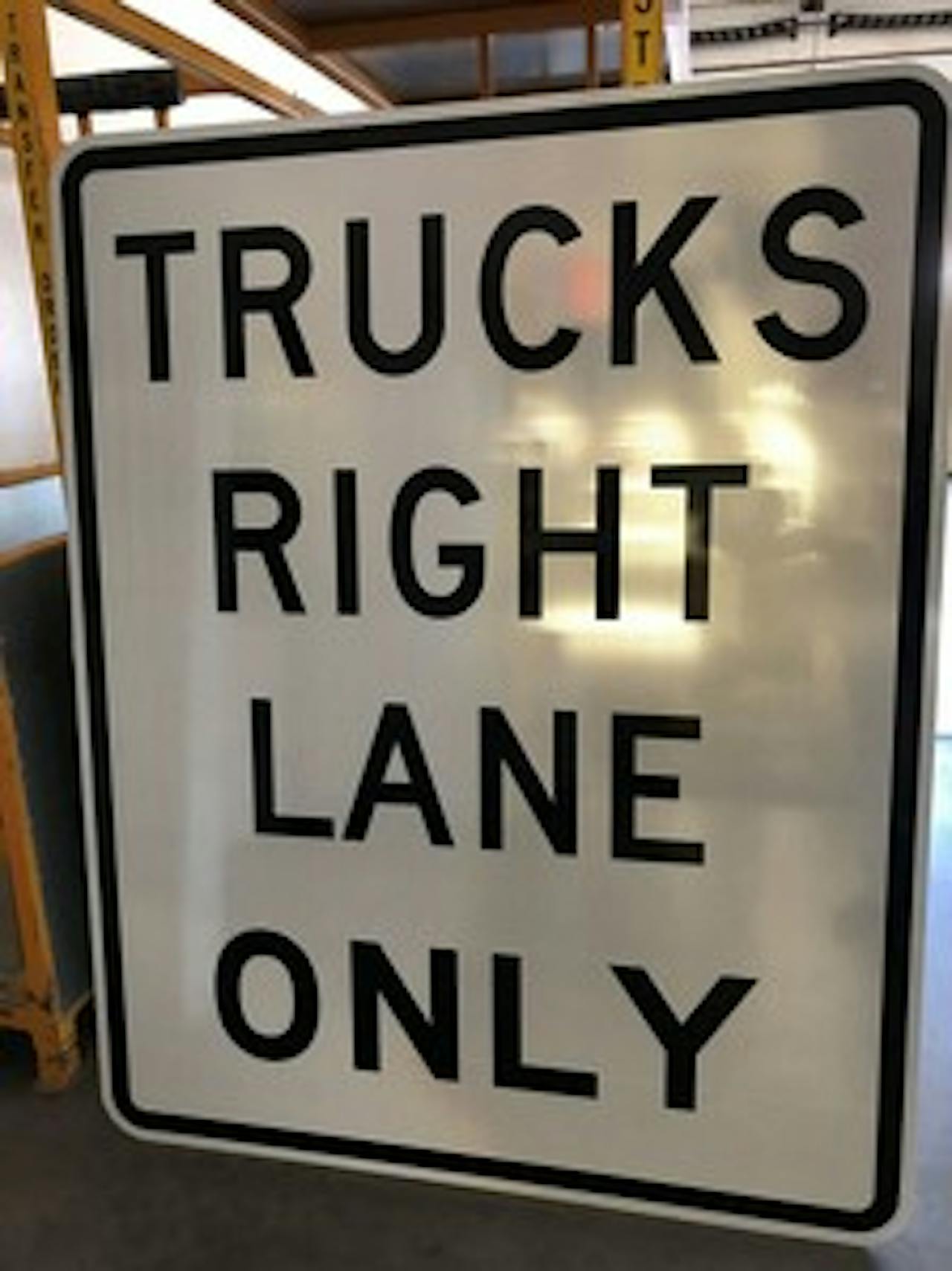 Trucks right lane only highway sign