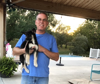 Brad Carman holding his dog