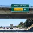 Truck headed past weigh station sign to Gilroy scale on SB 101 in California