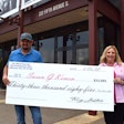 Tony Justice presents a large check for $33000 to Karin Moughler of Susan G. Komen foundation
