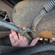 Florida Highway Patrol inspector points out a chafed brake air line hose