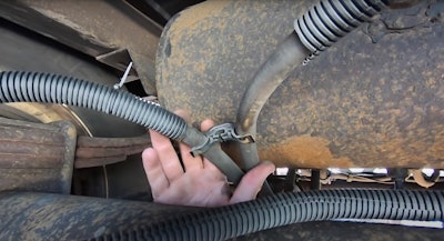 A trooper with the Florida Highway Patrol holds up a chafed brake hose during a Level 1 truck inspection (see the video posted below), which resulted in a violation that did not place the truck out of service, in this case.  Other violations can be more severe.  'Oftentimes the air lines will be held to a frame or structural member with flexible springs or tie-offs,' said Joe Kay, drivetrain engineering director at Meritor.  'Make sure these are in good condition to assure the air lines don't drag on the ground or rub on objects that can chafe.  Trailers tend to have longer air lines, especially on slider suspensions.