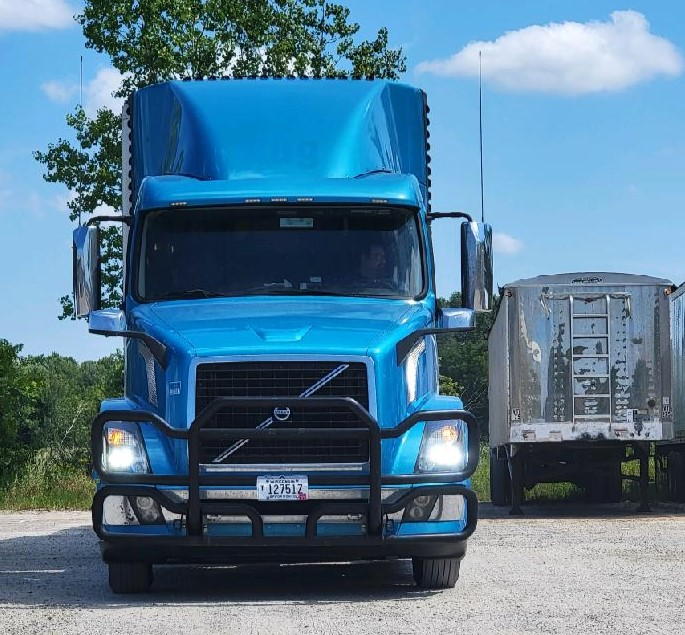 The longtime CDL holder and current trainer took his trainee recently through a practice session in straight backing, show above with one among trucks utilized in Suprise's fleet.