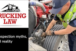 Officer inspecting a semi-truck next to the trucking law logo
